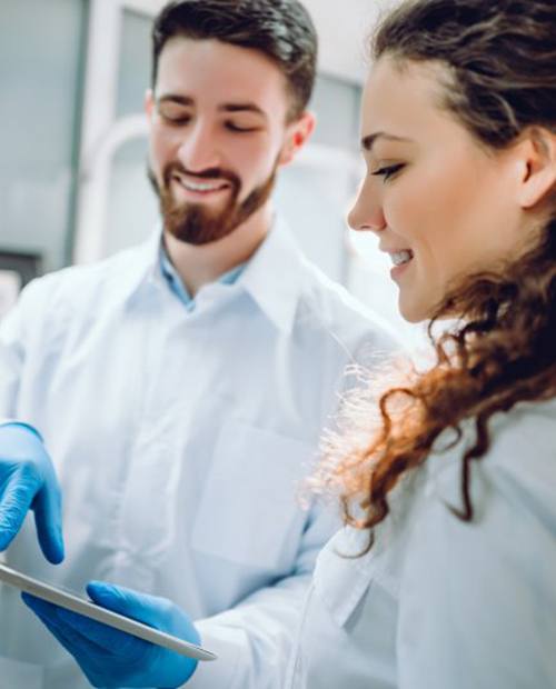 a dentist showing a patient a tablet