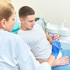 A dentist showing a nightguard to her patient