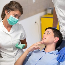 A dentist in Billerica showing patient X-rays during cancer screening