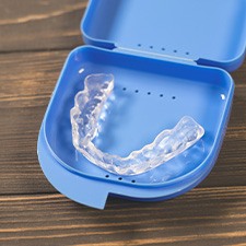 A nightguard placed inside a protective case