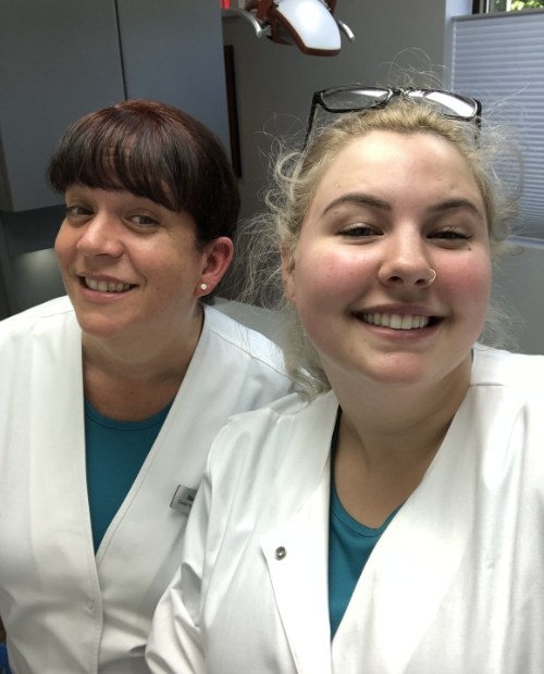 Two friendly dental team members