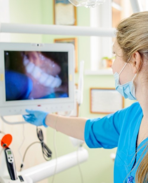 Dentist looking at smile images captured by intraoral camera