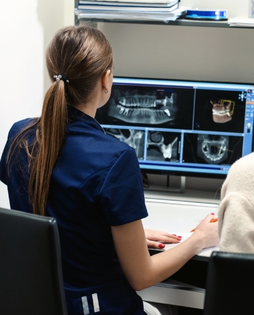 Dental team member looking at all digital x-rays on computer screen