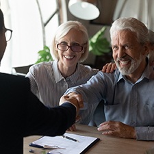 Couple smiling and laughing with dentures 