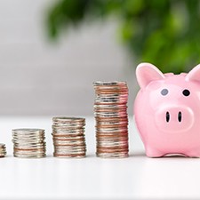 Coins next to a piggy bank