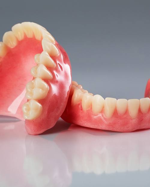 dentures against a gray background
