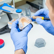 a lab technician crafting dentures