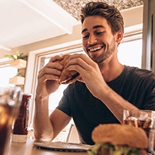 a man about to eat a hamburger