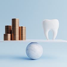 coins and tooth representing cost of emergency dentistry in Billerica