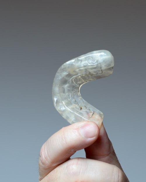 Hand holding an occlusal splint