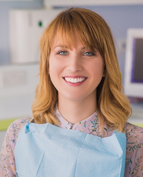 Woman with healthy smile after preventive dentistry checkup and teeth cleaning