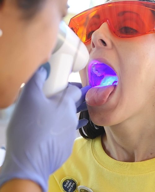 Dentist performing oral cancer screening