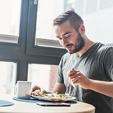 Man with dental implants in Billerica enjoying a meal