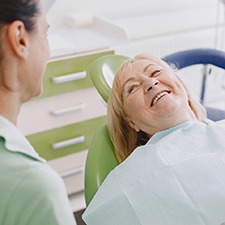 Woman smiling at her implant dentist in Billerica