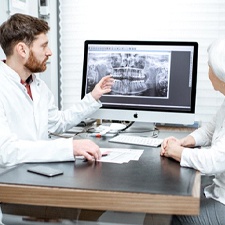 dentist showing a patient their X-rays