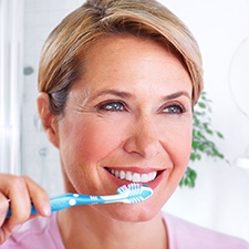 Woman brushing teeth in Billerica