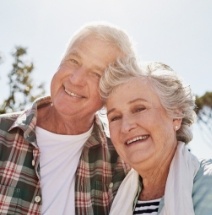 Older couple with healthy smiles after restorative dentistry