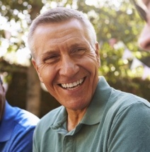 Man with healthy smile after replacing missing teeth