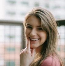 Woman with beautiful smile after orthodontics