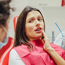 Woman with toothache in dental chair