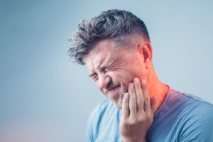 a patient struggling with dental pain