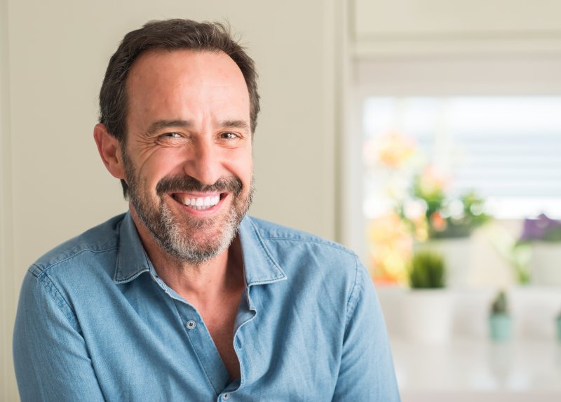 A man smiling with his composite dental fillings