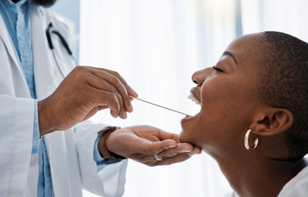 A woman recieving an oral cancer screening from her dentist