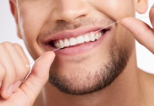 Man flossing his teeth