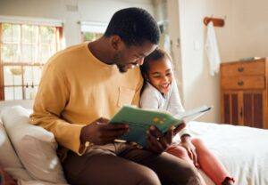 Father reading a book to his child